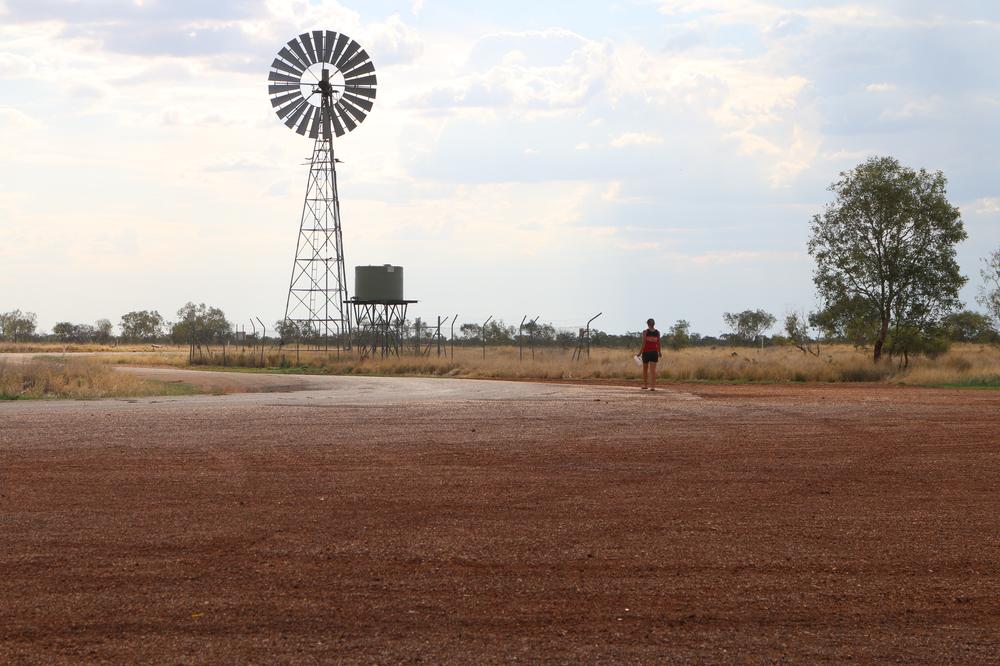 Anna walking toward a very welcome roadside water tank