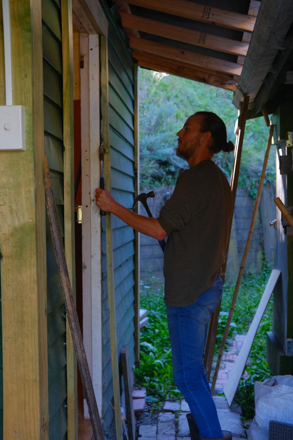 Prying the facade off Neville’s abominable door frame.
