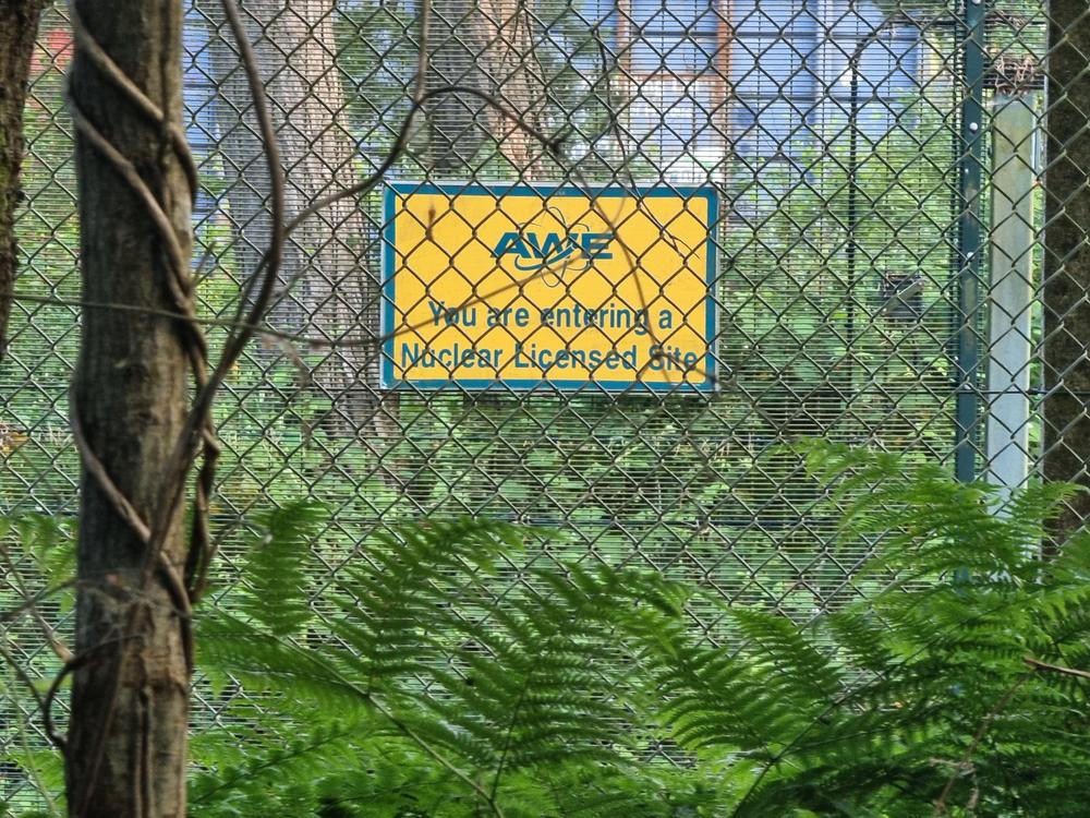 A sign on a fence reads ‘You are entering a nuclear zone’