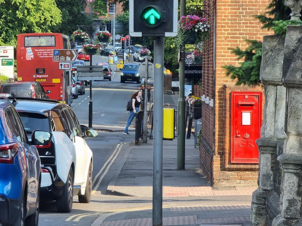 An uninteresting photo to all but a very few: red bus, red car, red letterbox