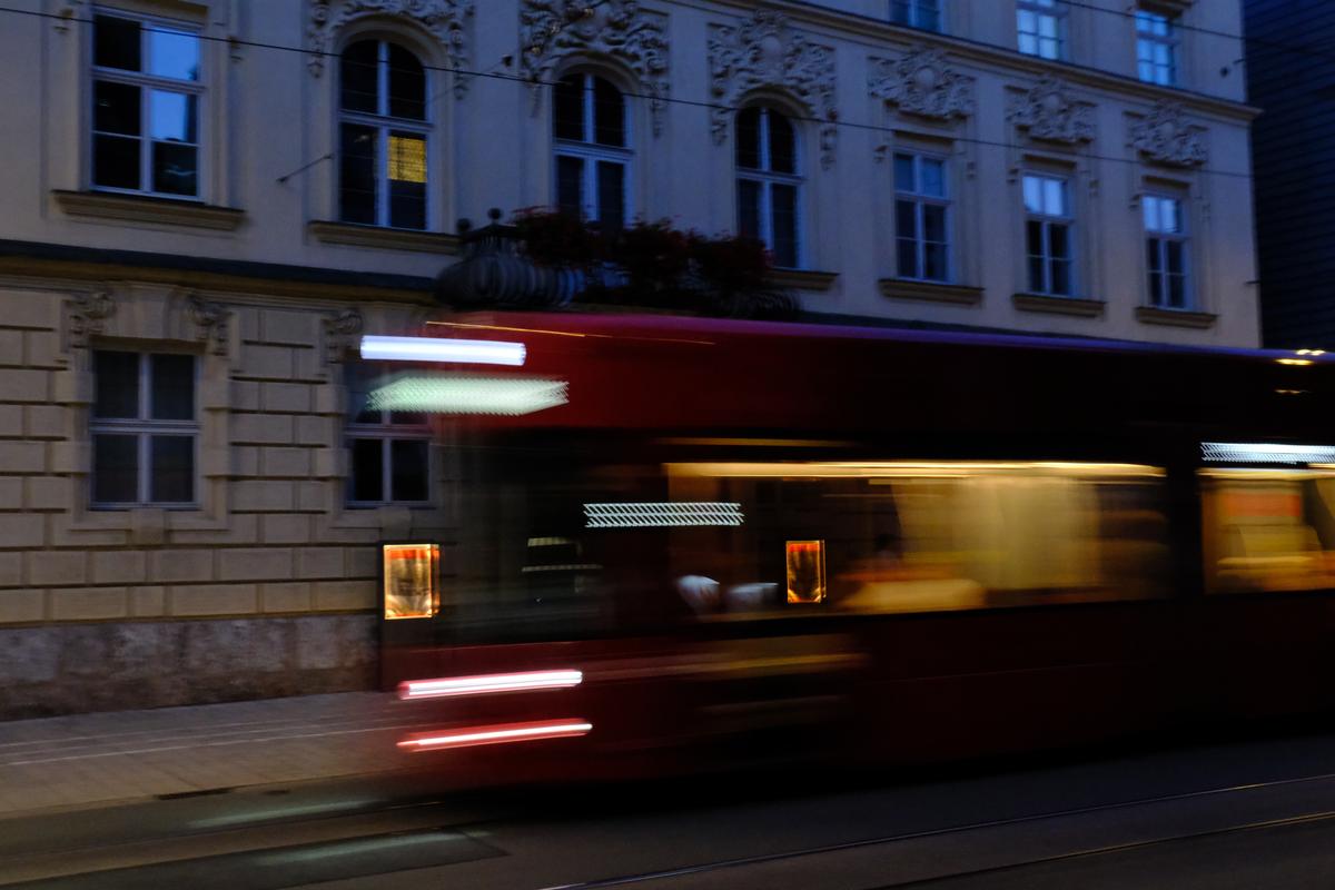 A red tram passes by in a blur. Innsbruck, Austria