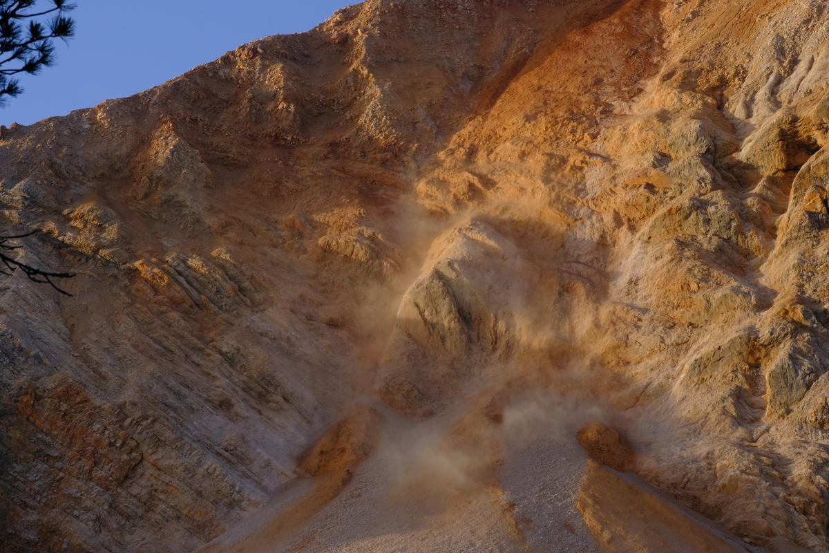 Dust hangs in the air after a rockfall in the Dolomites, Italy.