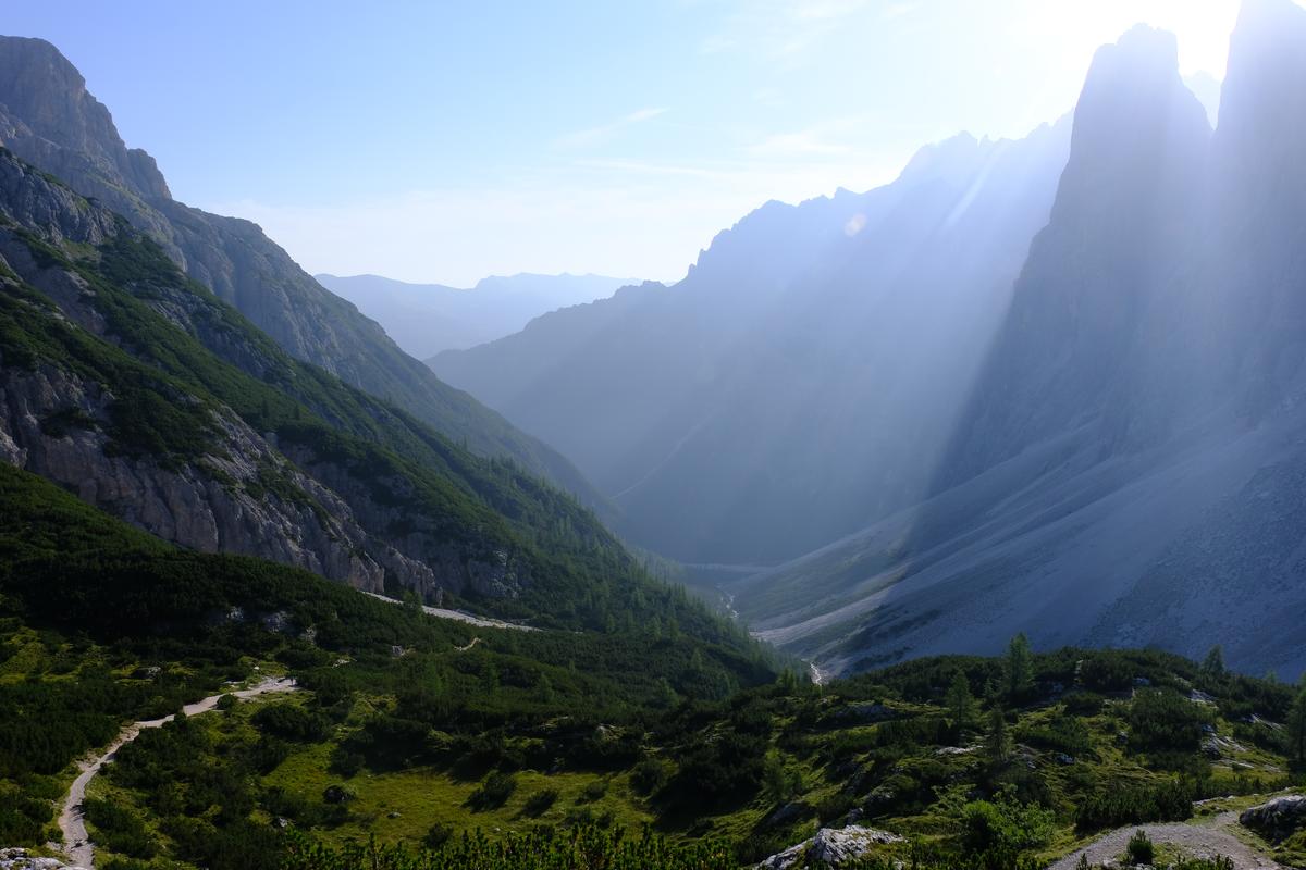 Morning sun rays already beating down on the western face of the valley while I make my descent. Tre Cime di Lavaredo, Italy