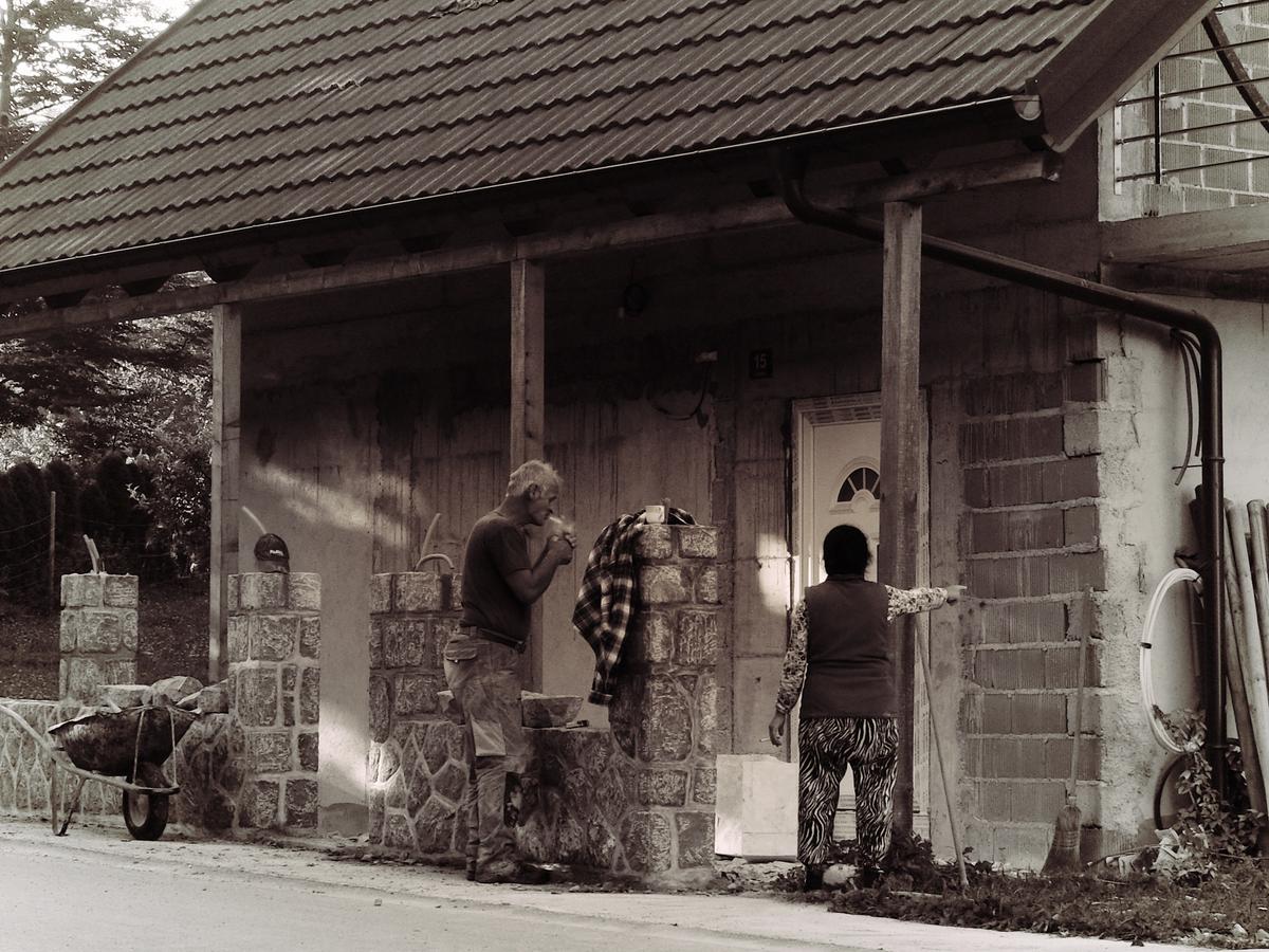 A warring husband and wife team disagreeing over the work to be done. The husband lights a cigarette and takes a deep drag before raising the decibels enough to end the discussion. Slovenia