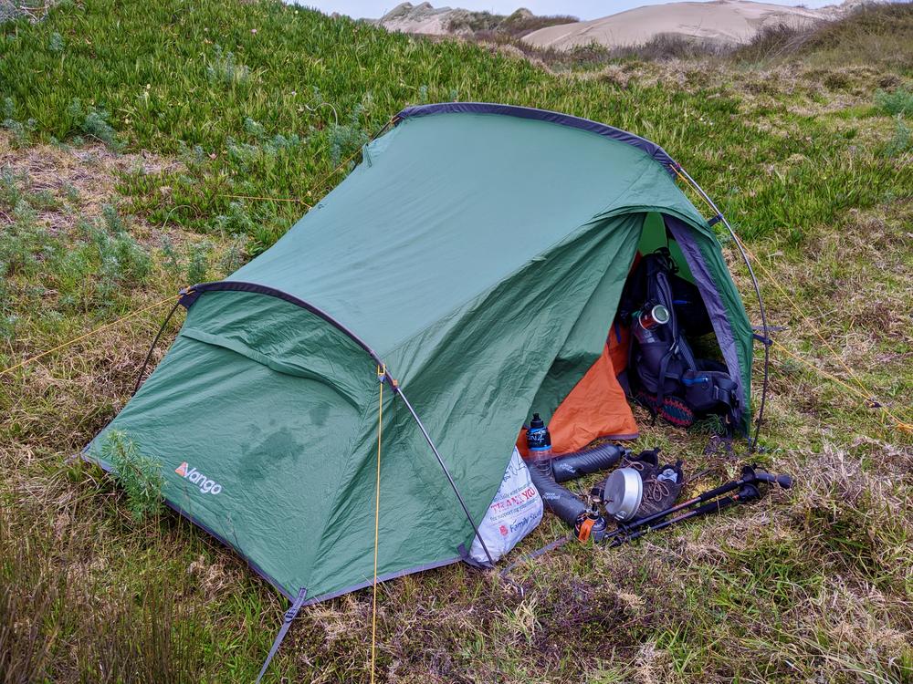 Our tent amongst the grasses behind the dunes.