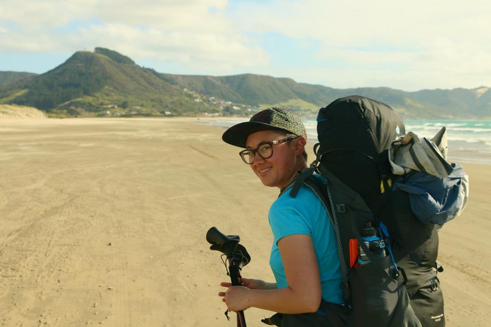 Houses dot the hillside in the distance behind Rose.